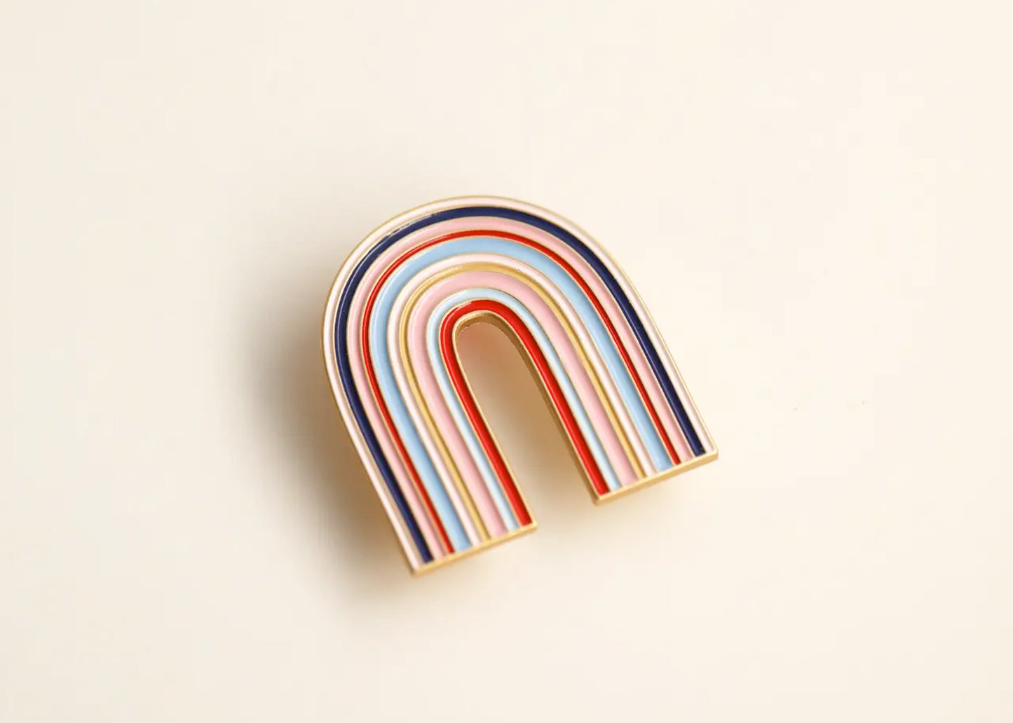Lisa Chow Large Rainbow Enamel Pin in The Grand Budapest Hotel
